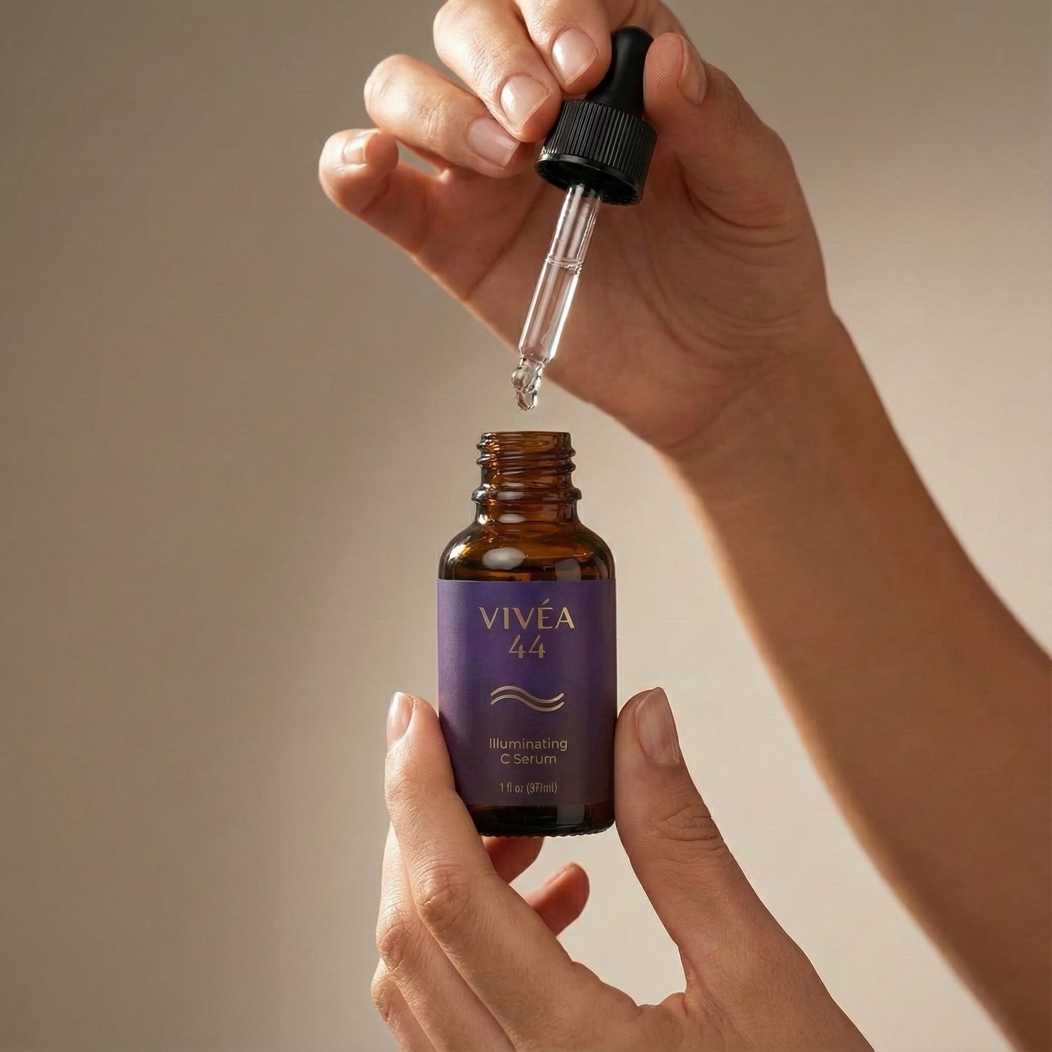 Vivea 44 skincare serum bottle with dropper held by a hand against a neutral background